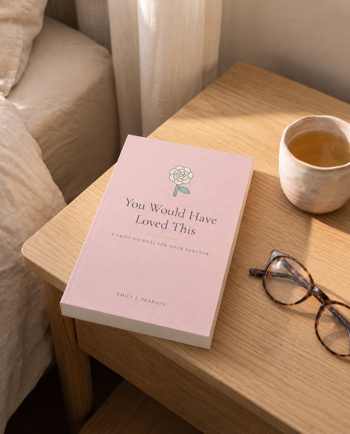 You Would Have Loved This, A Grief Journal for Your Partner, on a bedside table in morning light